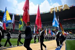 Pessoas carregam bandeiras de diferentes países durante a cerimônia de abertura da Copa do Mundo da FIFA 2026, na Cidade do México, em 11 de junho de 2026.