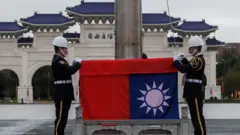 Taiwan's national flag is raised during an early morning flag-raising ceremony following China's People's Liberation Army said it would conduct live-fire drills in five designated maritime and airspace areas around Taiwan, in Taipei on December 30, 2025
