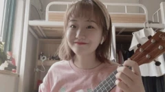 Zheng Linghua with a ukulele in her room