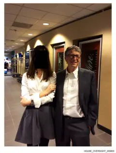 Una foto de Bill Gates junto a una mujer con la cara censurada. Están juntos en un pasillo, posando para la foto.