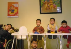 Orphans prepare to eat dinner at Shunyi Children's Home on January 28, 2005 in Beijing, China
