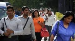 Morning commuters walk outside the Colombo World Trade Center in the central business district of Colombo, Sri Lanka,