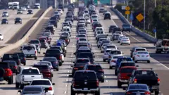  Drivers sit in traffic on Interstate 5 during the afternoon commute heading into downtown San Diego on October 4, 2024 in San Diego, California, US