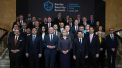 Britain's Home Secretary Yvette Cooper (C) poses with Summit attendees for a family photo during the International Border Security Summit in London, on March 31, 2025. Delegates from more than 40 countries gather in the UK on March 31 for a summit to be addressed by Britain's Prime Minister Keir Starmer seeking to crackdown on the "vile trade" in migrants. The interior ministers from France and Germany will be among those attending the two-day Organised Immigration Crime Summit in London, as the UK government struggles to contain migration numbers. (Photo by Kin Cheung / POOL / AFP) (Photo by KIN CHEUNG/POOL/AFP via Getty Images)
