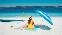 Woman sitting alone on the beach of Lake Salda
