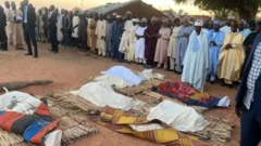 People laid on the mats, about to be buried