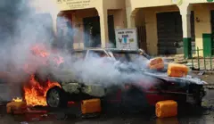 A car is on fire after a suicide bombing which was staged by a suspected female suicide bomber near a campaign rally at Pantami Stadium attended by President Goodluck Jonathan and also killed at least five people and injured 8 others in Gombe, Nigeria on February 02, 2015.