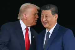 US President Donald Trump (L) talks to China's President Xi Jinping as they shake hands after their talks at the Gimhae Air Base, located next to the Gimhae International Airport in Busan on October 30, 2025.