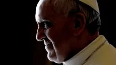 Pope Francis, standing in portrait in his private library, the Apostolic Palace, in the Vatican on 11 April 2013