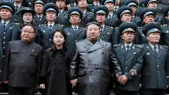 Kim Jong daa'imasaa (karaa bitaa) fi saayintistoota saatalaayitii basaasaa Kooriyaa Kaabaa hojjetan waliin guyyaa saatalaayitiin kun hojii eegale suuraa ka'