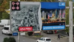 An election banner in Georgia contrasts peace in the country with devastation in Ukraine