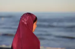 girl wearing red hijab looking away