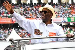 Le président ivoirien Alassane Ouattara salue ses partisans à son arrivée au stade olympique d'Ebimpe pour une réunion le 22 juin 2025 à Abidjan.