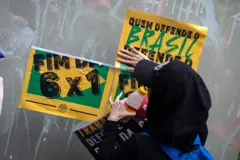 Manifestante cola cartazes por fim da jornada 6x1