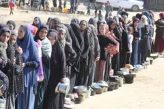 طابور طويل من الفلسطينييات ينتظرن الحصول على وجبة طعام في دير البلح بقطاع غزة