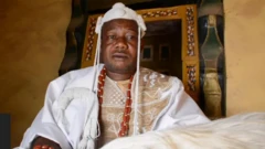 Ọba Joshua Adegbuyi Adeyemi, Aniyeloye II wọ agbada funfun pẹlu fila, o si mu irukẹrẹ lọwọ