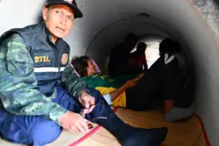 Mandatory Credit: Photo by KAIKUNGWON DUANJUMROON/EPA/Shutterstock (16044154b) Thai villagers take shelter under a concrete bunker following clashes between Thai and Cambodian troops in Phanom Dong Rak district, Surin province, Thailand, 08 December 2025. The Royal Thai Army has reported a Thai soldier was killed and other eight wounded in the multiple border area clashes between Thai and Cambodian troops after Cambodian troops attacked in the Phu Pha Lek hill of Phlan Hin Paet Kon area in Kantharalak district, Si Sa Ket province that prompted the evacuation of residents in four northeastern provinces bordering Cambodia, according to Thai Army spokesman Major General Winthai Suvaree. Villagers evacuate following Thai and Cambodian troops clashes over the border dispute, Dong Rak, Thailand - 08 Dec 2025