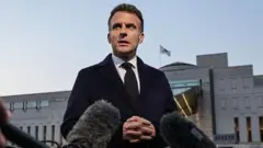 Macron speaking to reporters