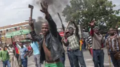 One group of anti-foreigner violent protesters hold weapons like hatchets, knifes and some oda metal objects, against immigrants during one anti-foreigner protest for Jeppestown suburb of Johannesburg, South Africa on April 17, 2015.