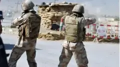 Pakistani security personnel are guarding a checkpoint in border region
