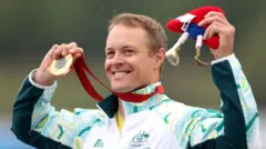 Australian gold medallist, Curtis McGrath celebrates on the podium during the Para Canoe, Men's Kayak Single 200m, KL2 medal ceremony