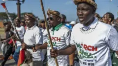 
Protesters from "March and March" Movement chant slogans during demonstration for Umlazi township south-west of Durban, on June 22, 2026. 