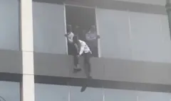 Man jumping window of Afriland building
