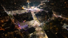 Fotografia aérea mostra manifestantes segurando seus celulares para iluminar o céu noturno em memória daqueles que morreram no desastre do telhado de Novi Sad