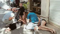 Una mujer herida es ayudada por transeúntes en Teherán tras un ataque israelí.