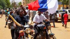 Двое африканцев на мотоциклах с российским флагом