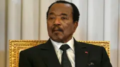 Paul Biya looking at di camera