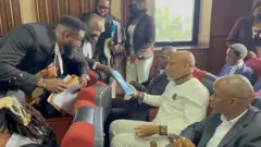 Nnamdi Kanu's lawyer, Aloy Ejimakor hands him a document in court - May 21, 2025