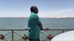 Mohamed Osman looks at the River Nile during the crossing between Sudan and Egypt