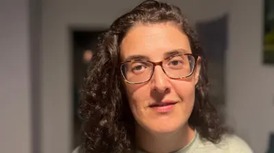 Елизавета Цуркова, женщина в очках и с вьющимися темными волосами