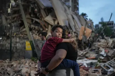 બચાવકર્મીઓ ઇમારતની નીચે દબાયેલા જીવિત લોકોને શોધી રહ્યા છે