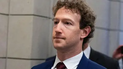 Mark Zuckerberg, CEO of Meta, wearing a dark blue suit and a dark red tie