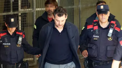 atalan regional police officers escort Jonathan Andic as he arrives at a court in Martorell, near Barcelona