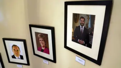 Photos of First Ministers of Scotland including Humza Yousaf, Nicola Sturgeon and Alex Salmond are displayed on a wall in Bute House, the official residence in Edinburgh on Monday