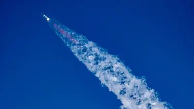 Starship blasting off in blue sky