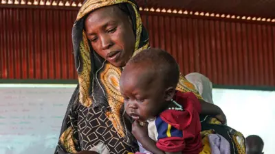 A woman and baby at the Zamzam displacement camp, close to El Fasher in North Darfur, Sudan, in January 2024