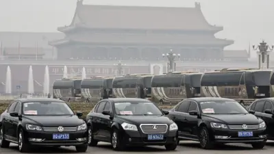 ars and buses for delegates sit parked near the Great Hall of the People in Beijing, China, on Friday, March 4, 2016