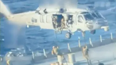 U.S. forces abseil onto an oil tanker during a raid described by U.S. Attorney General Pam Bondi as its seizure by the United States off the coast of Venezuela, December 10, 2025, in a still image from video