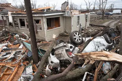 A home is reduced to rubble after being hit by yesterday's tornado on March 11, 2026 in Aroma Park, Illinois. 