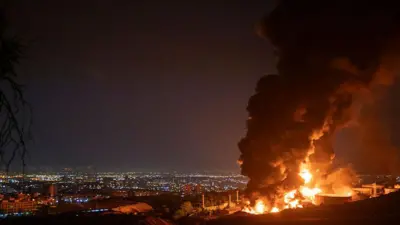 ستون‌های دود و آتش پس از حمله اسرائیل به انبار نفت شهران در آسمان تهران دیده می‌شود.