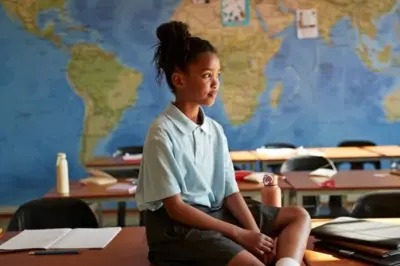 Umwana wicaye mu ishuri 