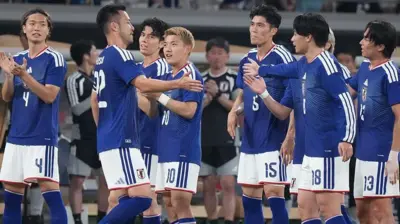青いユニホームを着た日本代表選手らが集まり声を掛け合っている
