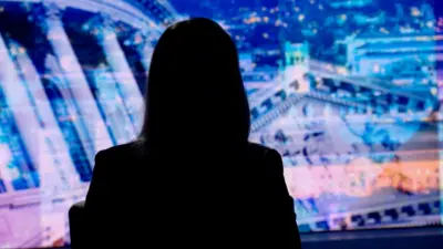 Silhouette of a woman in front of a blue patterned background