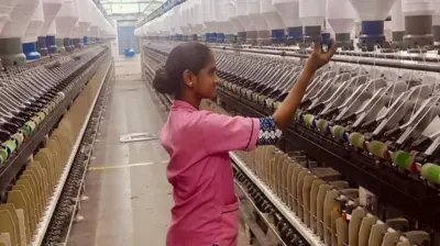 A woman wearing a pink shirt at a spinning mill factory in the southern Indian state of Tamil Nadu. 