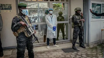 M23 soldiers provide security for di movement authorities for di Rodolphe Mérieux Laboratory, National Biomedical Research Institute (INRB) in Goma, on May 19, 2026 during dia guided visit to di laboratory responsible for analyzing and handling suspected Ebola cases
