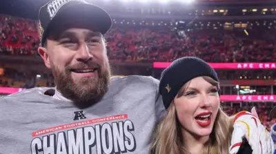 Travis Kelce and Taylor Swift smiling after the Kansas City Chiefs beat the Buffalo Bills in January 2025